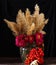 Floral and berry autumn still life on a dark background. Beautiful rustic still life with reed panicles, chrysanthemum flowers,