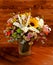 Floral bouquet with lily, sunflower, chrysanthemum, eustoma lisianthus astrantsiya, eucalyptus, shrub rose on wooden board