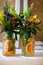 Floral bouquets in jars with oranges