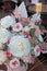 Floral bunch in round box. Bouquet in peach color of beautiful preserved flowers. White rose , mixed roses flowers, dried palm