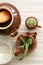 Floral compositio with cactuses in ceramic pots, a teapot and a mug, a bottle of dark glass, kitchen, horizontal photo, dark