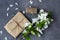 Floral composition. Pretty gift box wrapped with brown craft paper