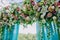 Floral decoration with blue cloth for wedding ceremony. Wedding arch with beautiful flowers