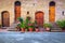 Floral entrance and wooden door in Tuscany, Pienza, Italy