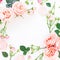 Floral frame of pink roses, buds and leaves on white background. Flat lay, top view. Floral background.