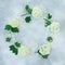 Floral frame of white hydrangea branches on gray. Flat lay