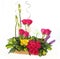 Floral gift arrangement made with red roses with long stems and yellow flowers inside a wooden pot