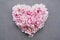 Floral heart made of beatiful fresh pink peonies in full bloom.