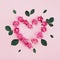 Floral heart made of pink rose flowers and green leaves on pastel background top view. Flat lay styling. Fashion composition.