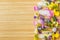 Floral Ice Pops and fresh summer flowers with space for text. Colorful wildflowers in melting ice hearts and popsicles on wooden