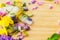 Floral Ice Pops and fresh summer flowers with space for text. Colorful wildflowers in melting ice hearts and popsicles on wooden