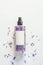 Floral moisturizing mist spray bottle with natural purple flowers petals