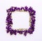Floral pattern square Frame made of small forest flowers violet with empty space for text on a on white background