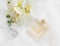 Floral perfume bottle with orchid, overhead shot