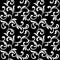 Floral seamless pattern. White swirls and foliage isolated on a black background.