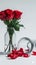 Floral simplicity Glass vase with red roses on clean white backdrop