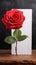 Floral simplicity Red rose with white paper on rustic tabletop
