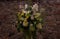 Floral work on a stand with white hydrangea on a stone wall