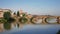 Florence, bridge through river Arno is reflected in water