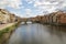 Florence, Italy - September 03,2017: Beautiful view downriver to the Ponte Vecchio old bride in the blue sky and cloud