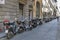 Florence old narrow street with parked scooters and motorbikes