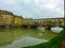 Florence - Scenic view of historic medieval Ponte Vecchio bridge with shops spanning the Arno River, Firenze