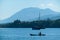 Flores/Indonesia 20290808: A fisherman`s boat crossing sea near Maumere, Indonesia There is one man in the boat, wearing straw ha