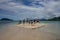FLORES/INDONESIA-JANUARY 04 2014: some people enjoy summer friendships, jumping happily on an uninhabited beach, white sand on the