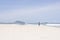 FLORIANOPOLIS, BRAZIL - JANUARY 22, 2023 : a man walks on the beach Barra da lagoa, Florianopolis, Brazil