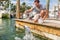 Florida tourism summer vacation attraction tourist man having fun feeding tarpon fish in the keys, USA travel lifestyle