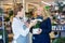 Florist Assisting Happy Female Customer In Buying