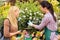 Florist give advice to customer woman plants