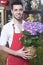 Florist Holding Hydrangea Flower Plant In Shop