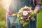 Florist holds flower bouquet in hand