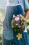 Florist holds flower bouquet in hand