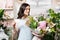 Florist looking at festive bouquet while