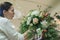 Florist make winter wedding bouquet composition indoors
