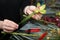 Florist makes a gift bouquet in a flower shop.