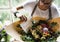 Florist Making Fresh Flowers Bouquet Arrangement with Happy Anniversary Card