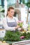 Florist Making Rose Bouquet In Flower Shop