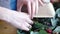 Florist using stapler to attach a craft paper. Close up view of arranging bouquet