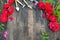 Florist vintage gardening set with red roses and tools on wooden table