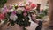 Florist woman arranges fresh spring bouquet in flowershop