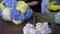 Florist woman making big bouquet of hydrangea flowers in shop, hands closeup.