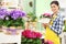 Florist woman smiling with white wicker basket flowers