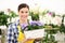 Florist woman smiling with white wicker basket flowers