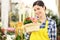 Florist woman smiling with white wicker basket flowers primro