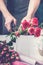 Florist at work. Female hands collect a wedding bouquet of roses. Small business concept