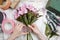 Florist at work: woman arranging bouquet of alstroemeria flowers