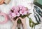 Florist at work: woman arranging bouquet of alstroemeria flowers